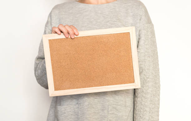 istock Woman holding a cork board 824583986