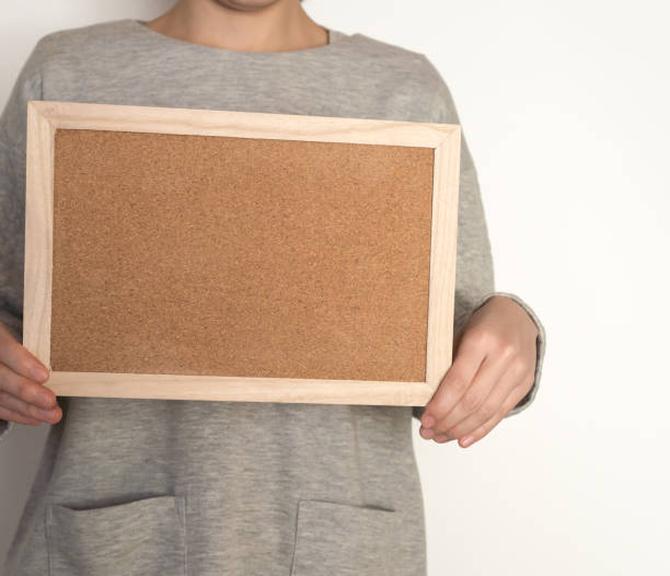 istock Woman holding a cork board 824584006