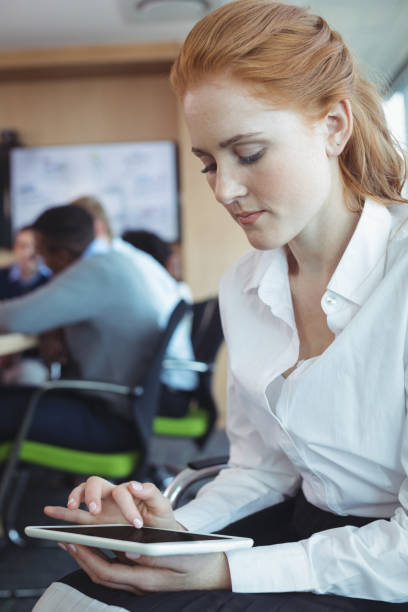istock Young businesswoman using digital tablet at office 824588820