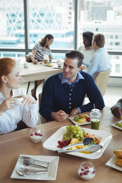 istock Young business colleagues talking at breakfast table 824588852