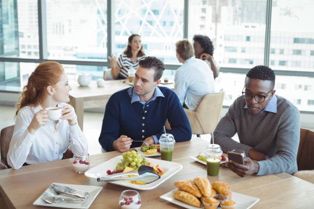 istock Business entrepreneurs sitting at breakfast table in office 824588860