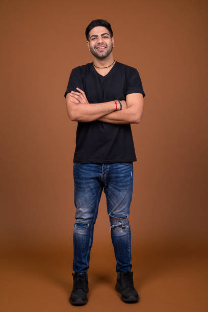 istock Studio shot of young handsome Indian man against colored background 824589592