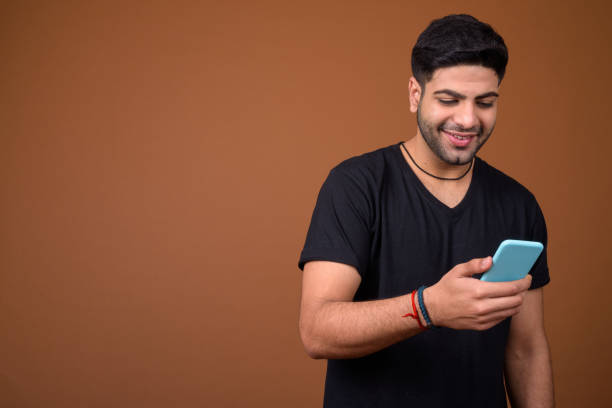 istock Studio shot of young handsome Indian man against colored background 824589770