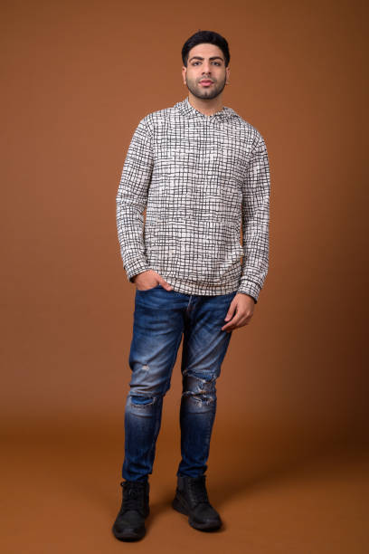 istock Studio shot of young handsome Indian man against colored background 824589774