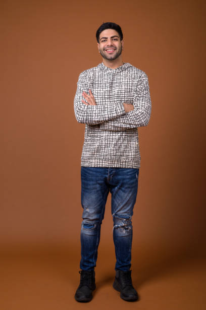 istock Studio shot of young handsome Indian man against colored background 824589840
