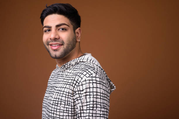 istock Studio shot of young handsome Indian man against colored background 824589954