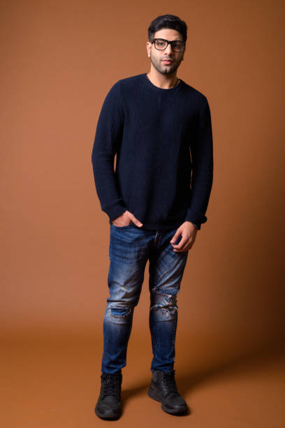 istock Studio shot of young handsome Indian man against colored background 824589986