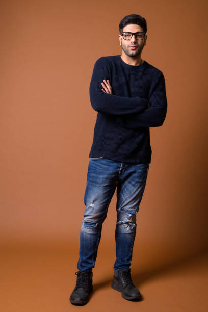 istock Studio shot of young handsome Indian man against colored background 824590004