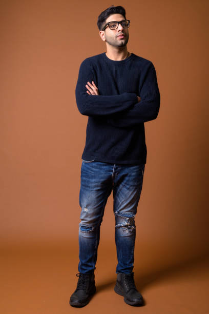 istock Studio shot of young handsome Indian man against colored background 824590016