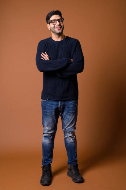 istock Studio shot of young handsome Indian man against colored background 824590018
