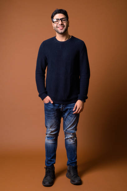 istock Studio shot of young handsome Indian man against colored background 824590030