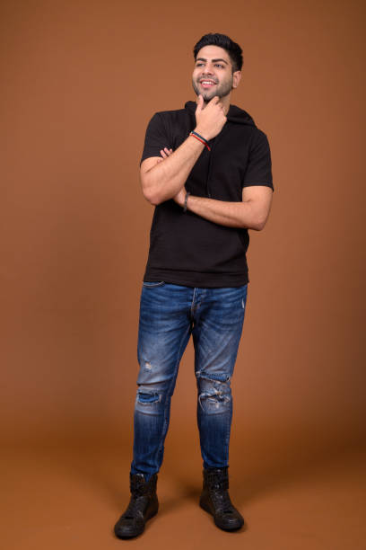 istock Studio shot of young handsome Indian man against colored background 824590142