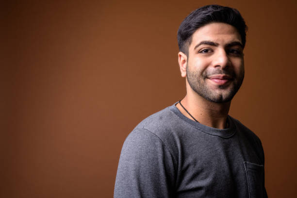 istock Studio shot of young handsome Indian man against colored background 824590272