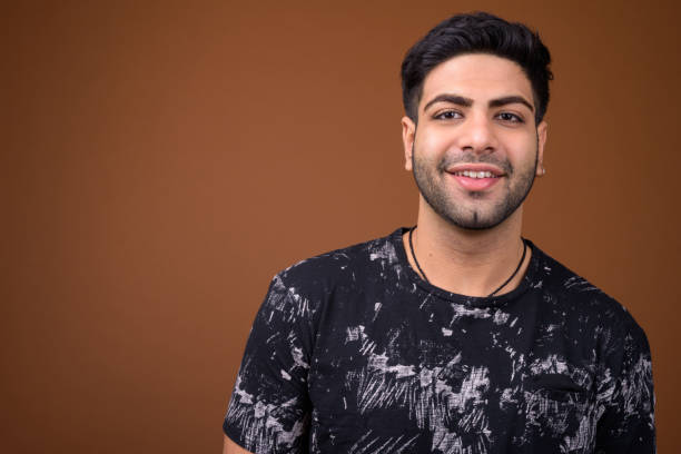 istock Studio shot of young handsome Indian man against colored background 824590336