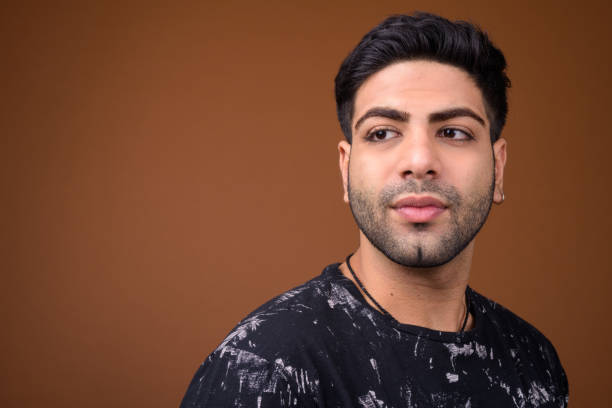 istock Studio shot of young handsome Indian man against colored background 824590348