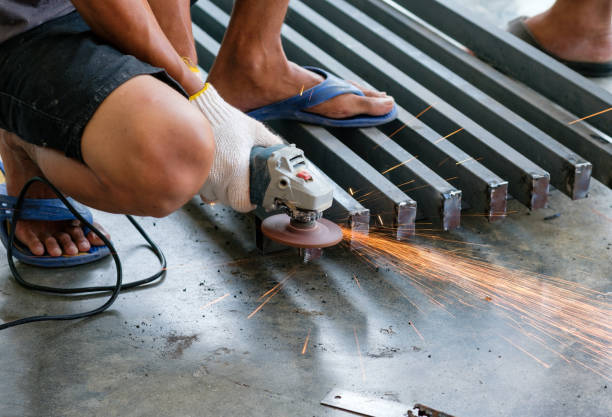 istock Worker cutting metal with grinder with sparks 824592130