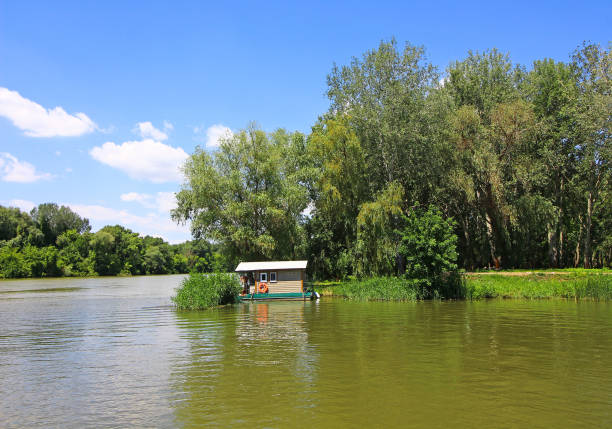 istock Little house next to the river Tisza 824595600