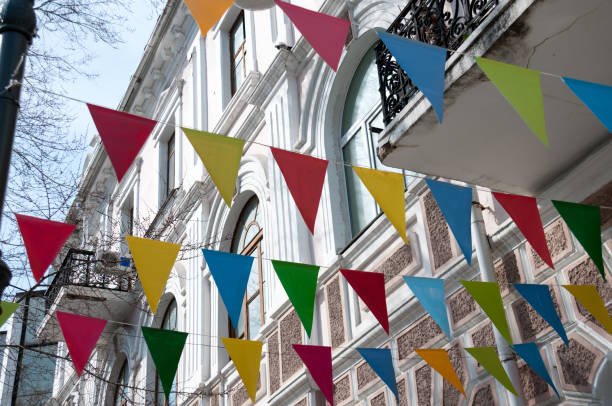 istock Decorative multi colored triangle flags against the background of city 824597068