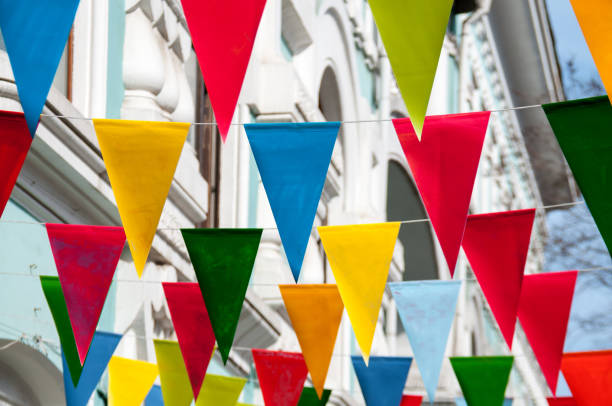 istock Decorative multi colored triangle flags against the background of city 824598164