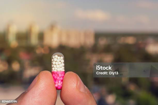 Tablet In The Hands Of A Person On The Background Stock Photo - Download Image Now - Capsule - Medicine, LSD, Pill