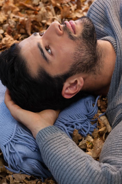 istock Overhead of man lying on autumn leaves 824603984