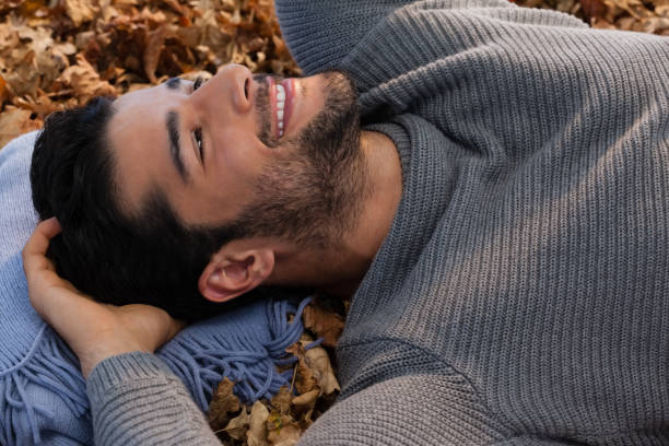 istock Overhead of man lying on autumn leaves 824604028