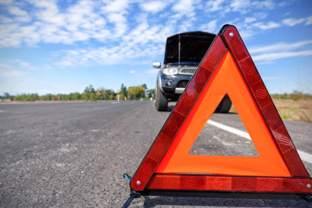 istock Red emergency stop sign and broken car on the road 824606828