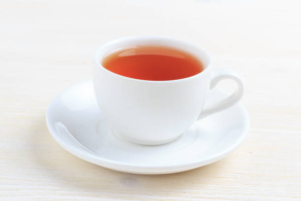 istock Cup with green tea on a saucer on a white background 824609780