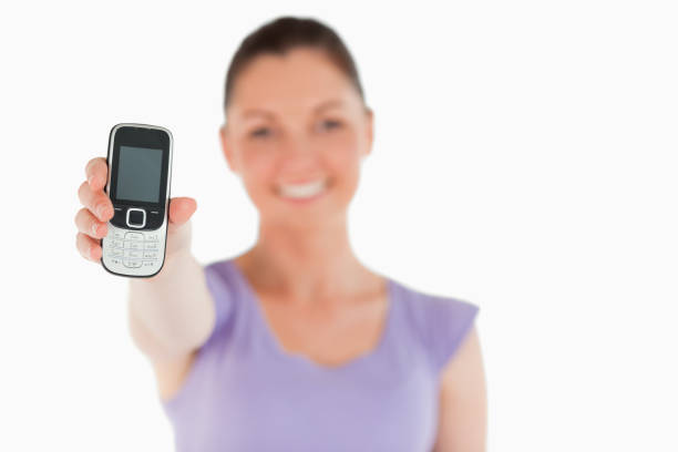 istock Attractive woman holding and showing her phone while standing 824609806