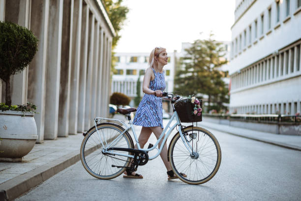 istock Happy woman in downtown with retro bicycle 824609974