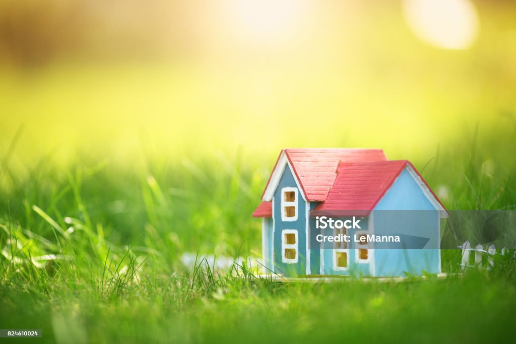 wooden house on the grass wooden house model on the grass in garden House Stock Photo