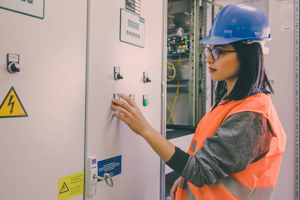 istock Young female maintenance engineer working at energy control room 824611666