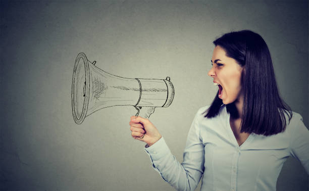 istock angry woman screaming in megaphone 824613250