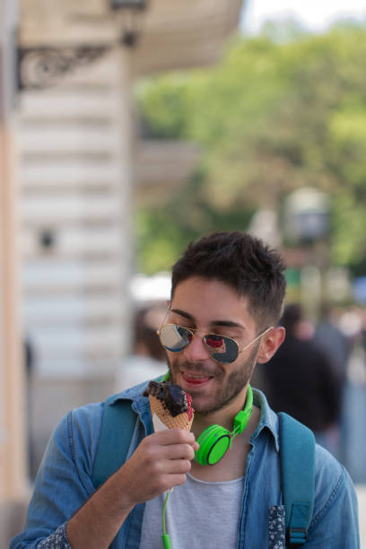 istock Young Adult Man Eating Ice-Cream 824616224