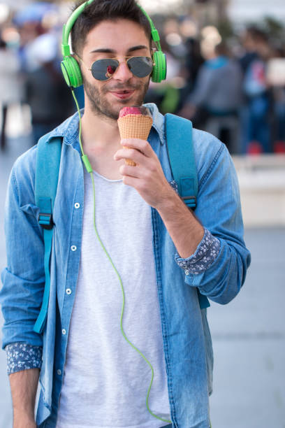 istock Young Adult Man Eating Ice-Cream 824616238