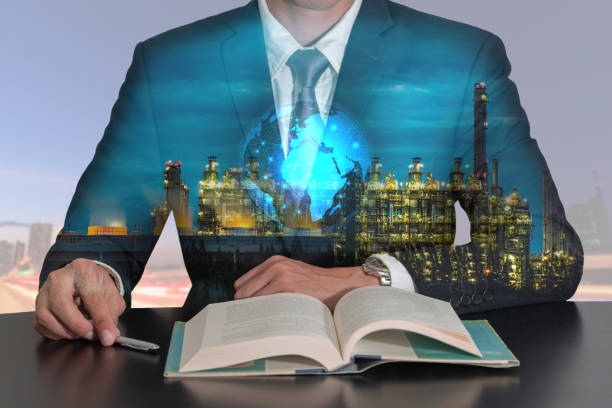 istock Businessman open book, glowing technology world map, electric generating factory 824617720