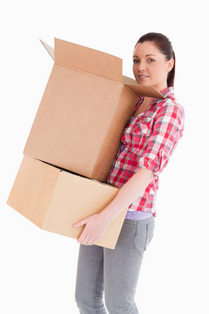 istock Good looking woman holding cardboard boxes while standing 824618106