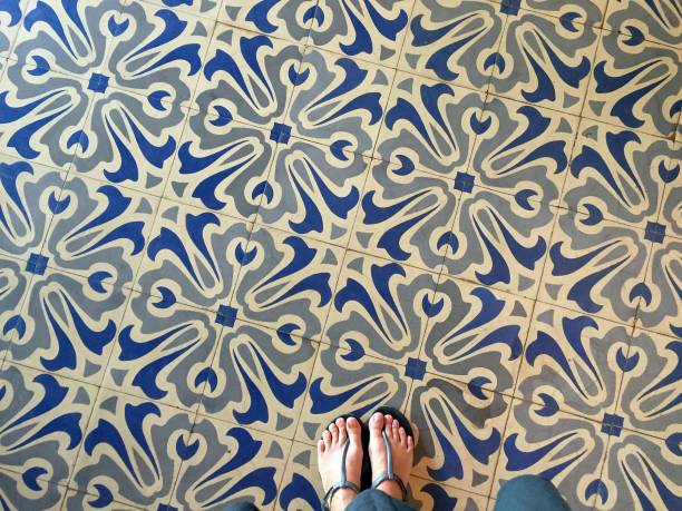 istock Feet over vintage tiled floor 824618520