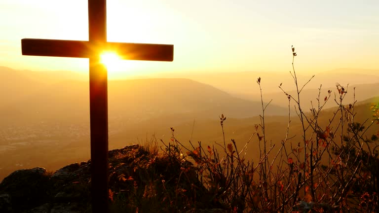 Crucifix on Mountain during Sunset. Beautiful Nature and Calm Atmosphere.