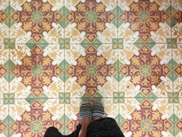 istock Feet over vintage tiled floor 824619312