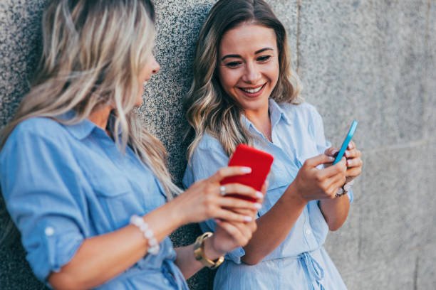 istock Twins texting in the city 824620968