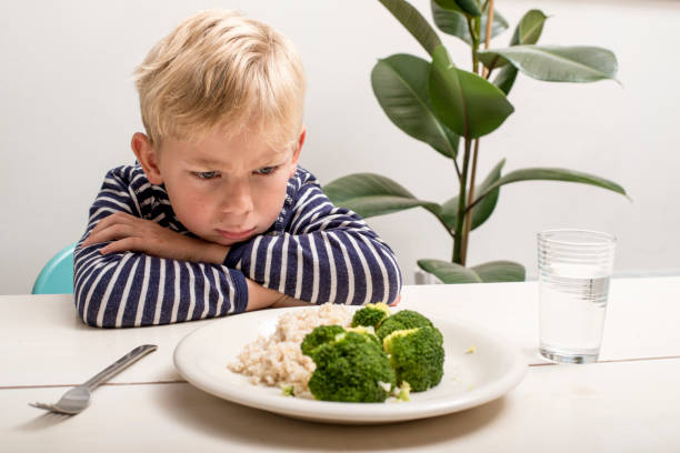 ragazzo non vuole mangiare le sue verdure - childrens food foto e immagini stock