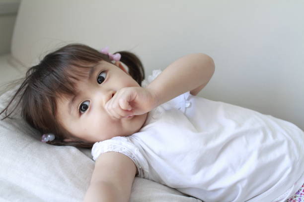 lying Japanese girl with sucking her finger (2 years old)