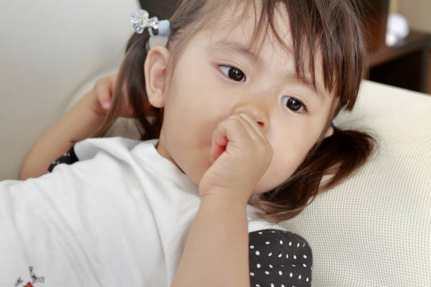 istock lying Japanese girl with sucking her finger (2 years old) 824626784
