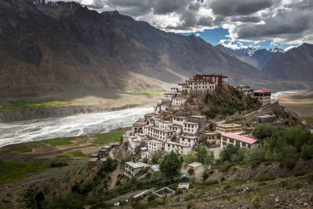 key monastery or ki monastery key monastery or ki monastery, spiti valley, himachal pradesh, india surrounded by mountains, river and clouds gompa stock pictures, royalty-free photos & images