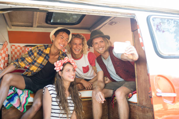 istock Happy young friends taking selfie in camper van 824632030