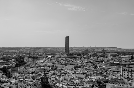 A black and white picture of Seville`s skyline focusing on the Sevilla Tower.