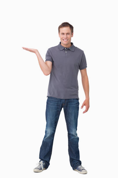 istock Smiling young man presenting with his palm up 824635370
