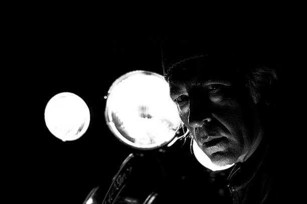 istock high contrast biker in front of headlights 824640634