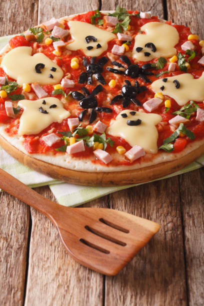 istock Pizza Halloween with ghosts cheese and olives spiders close-up. vertical 824640922